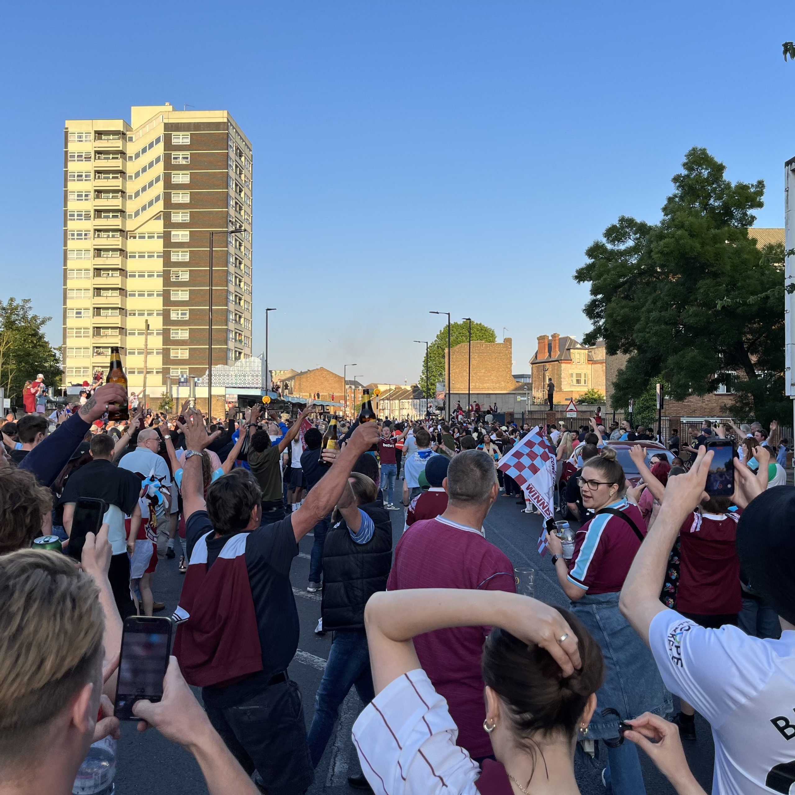 Outside the Black Lion in Plaistow, London, UK, at 7.45pm on Thursday 8th June 2023, for the passing of the open top bus following West Ham’s victory in the Europa Conference League Final – by Alan Hall